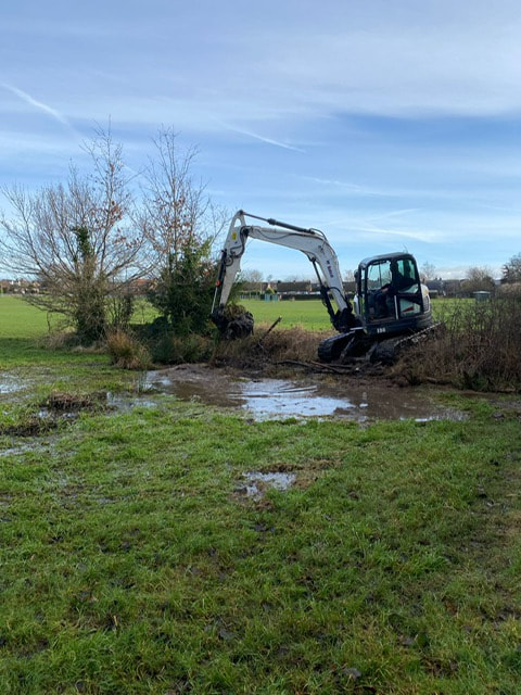 Mechanical digger starting work on the new pond 